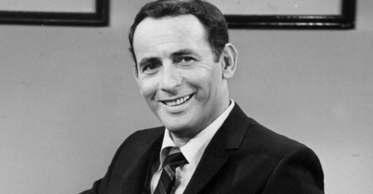 Joey Bishop smiling and posing for a publicity photo for his television show.
