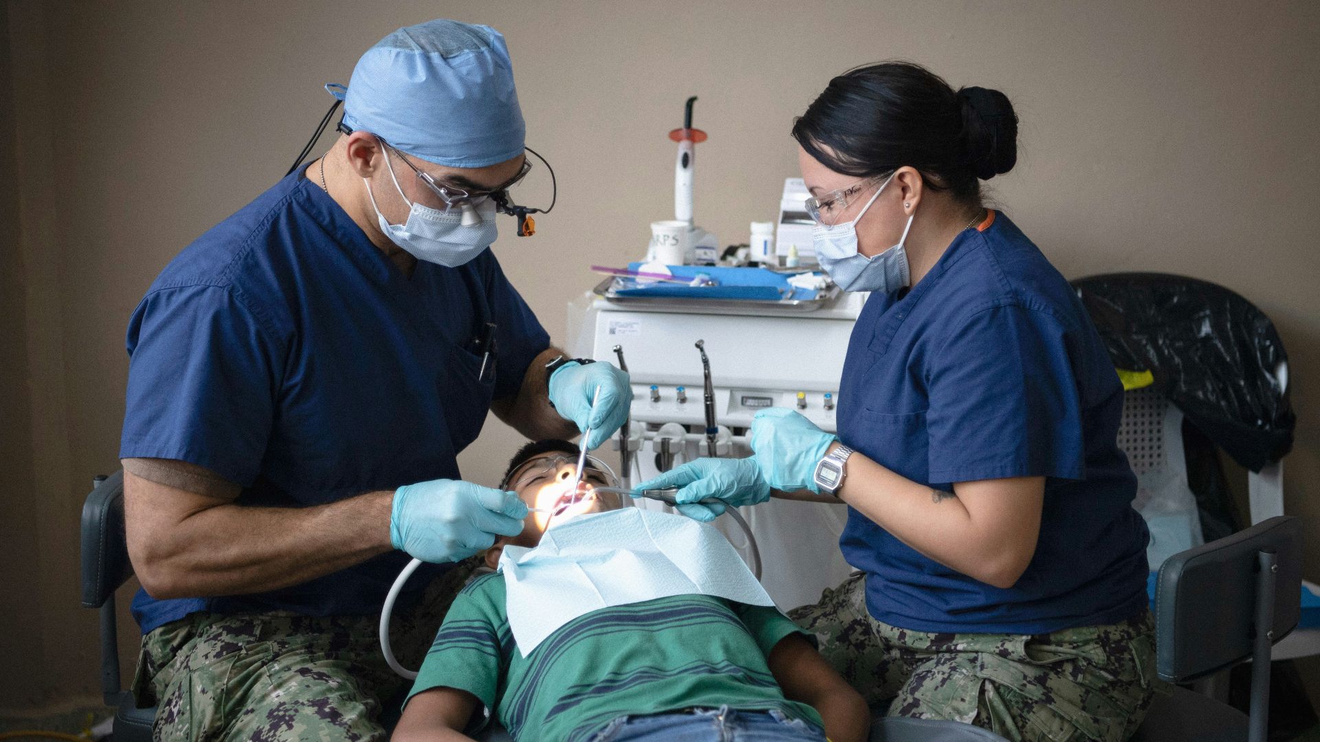 Dentists providing dental care to a patient.
