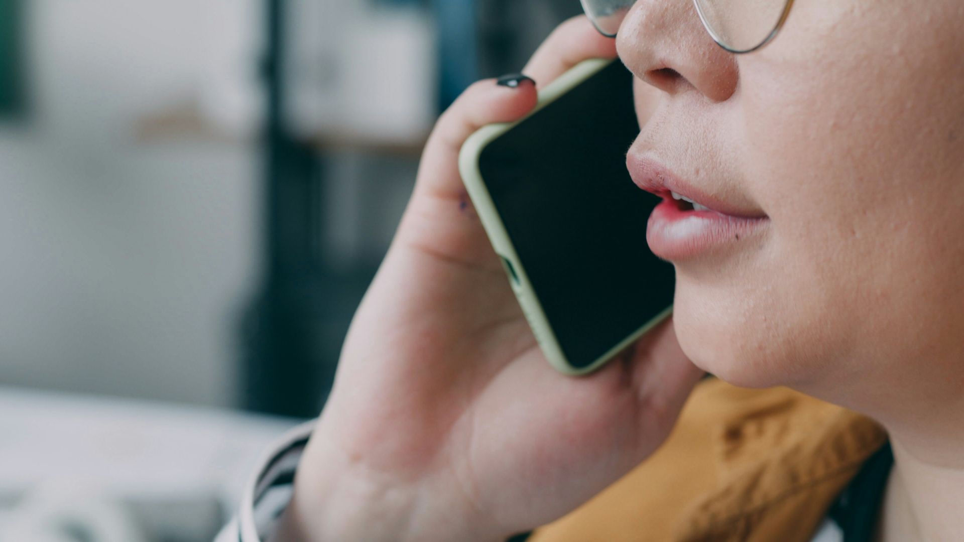 A woman with glasses talking on a cell phone