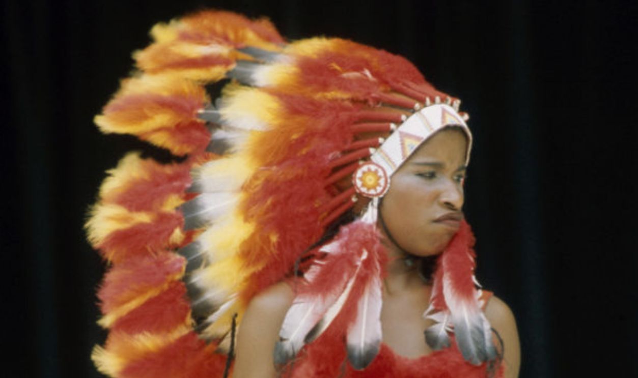 Chaka Khan, lead singer of American funk group Rufus, performing in a native American costume, circa 1975.