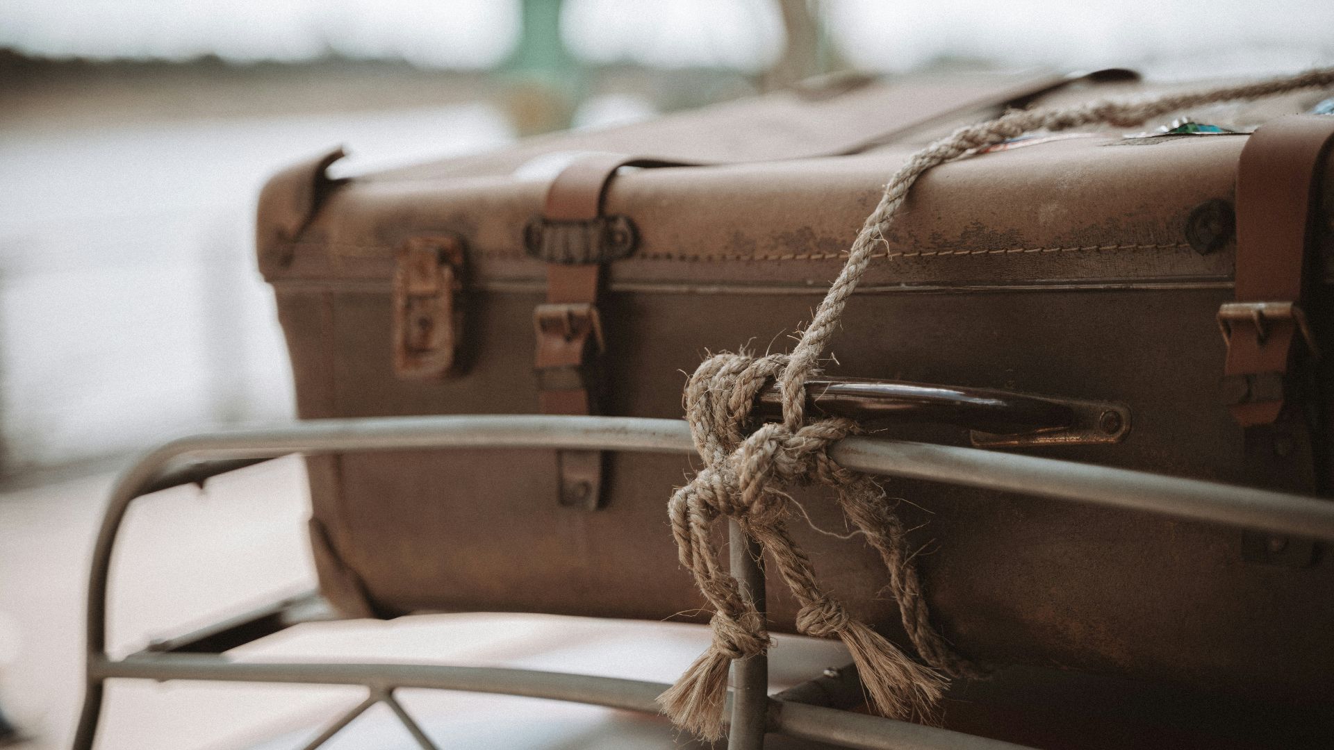 a couple of suitcases sitting on top of a metal chair