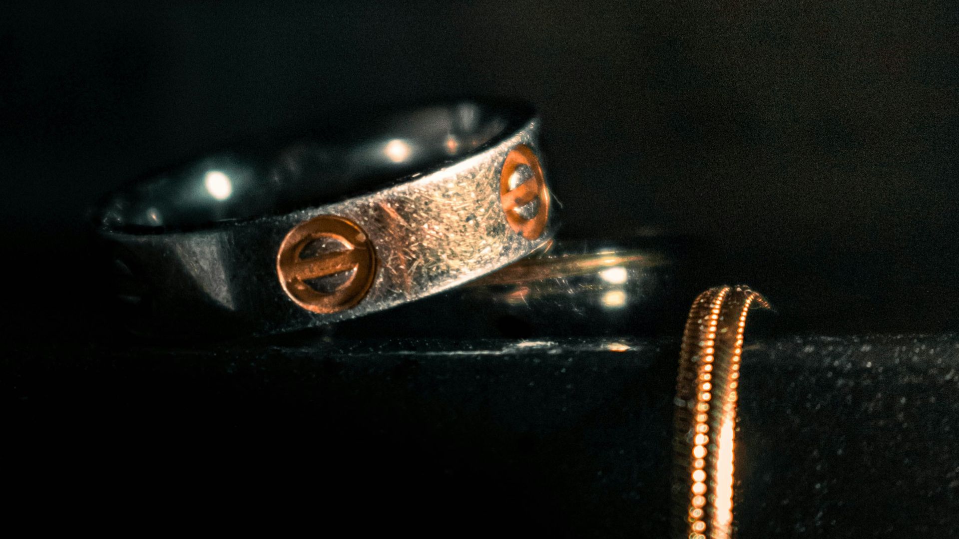 two rings sitting on top of a black table