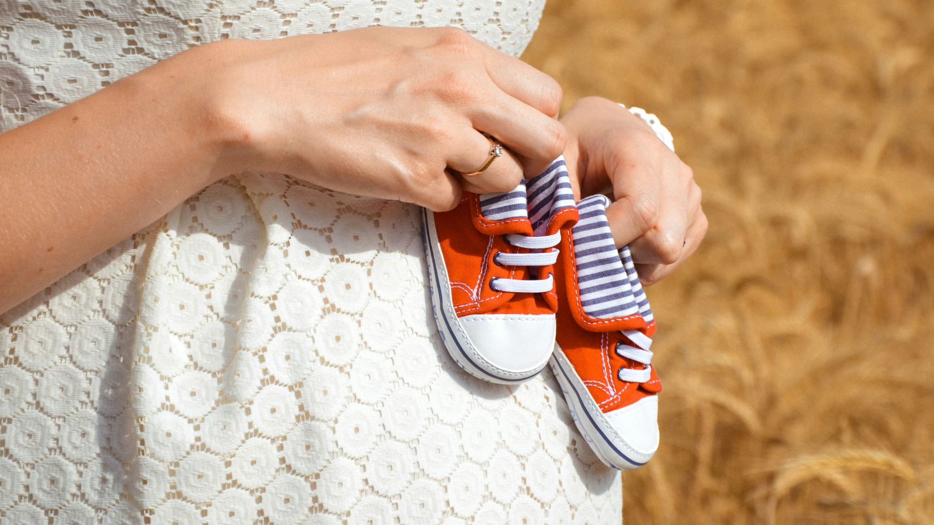 person holding white and red plastic toy car