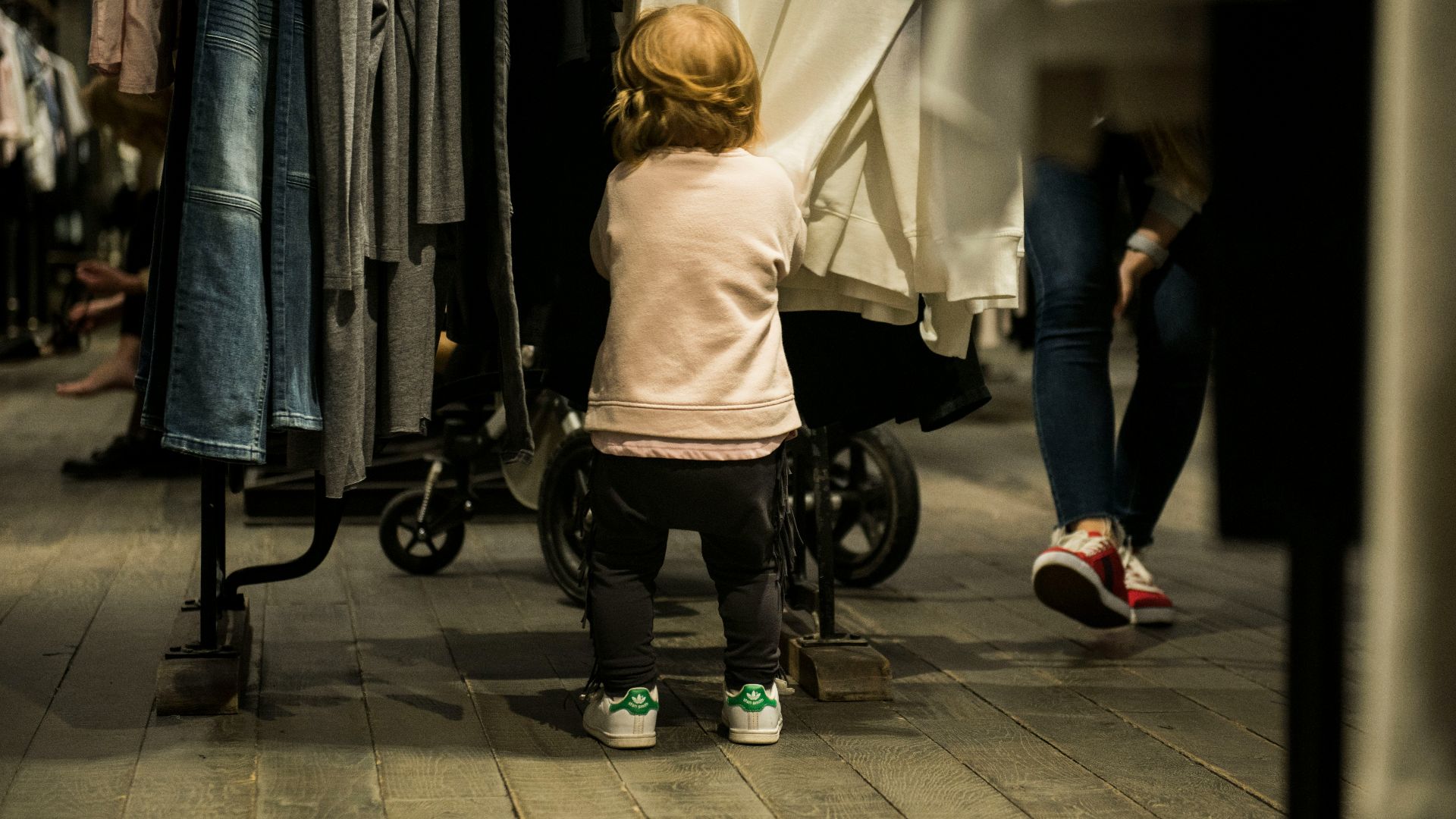 girl standing near clothes
