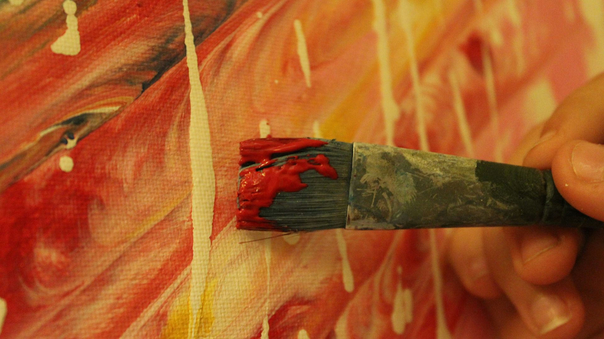 a person holding a paintbrush in their hand