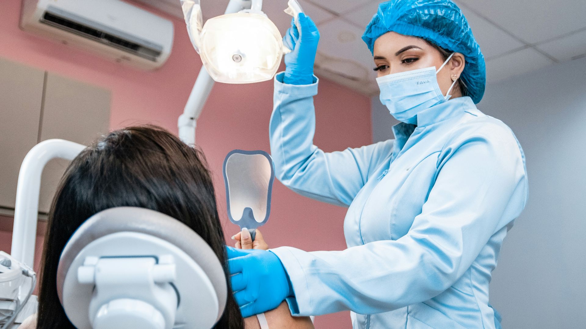 a woman getting her teeth checked by a dentist