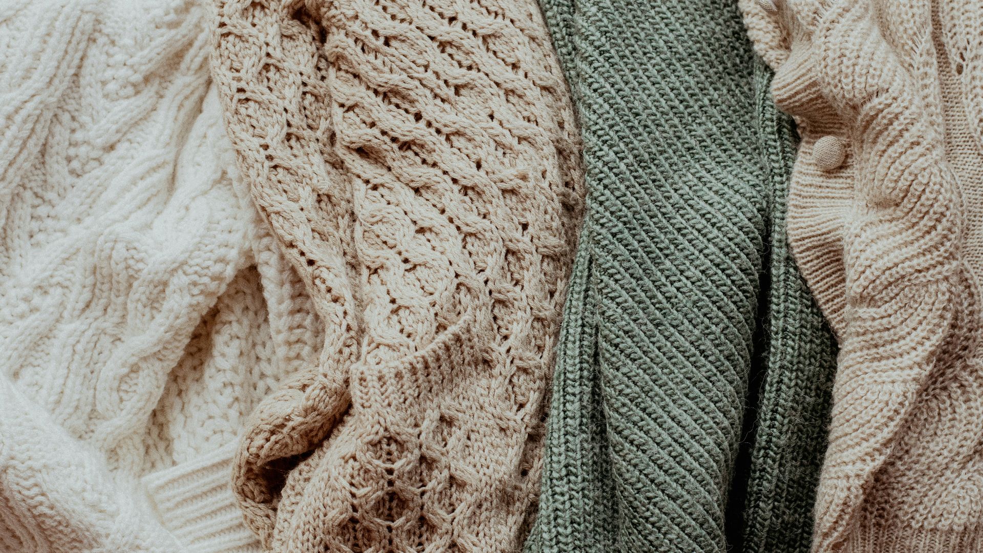 a pile of sweaters sitting next to each other