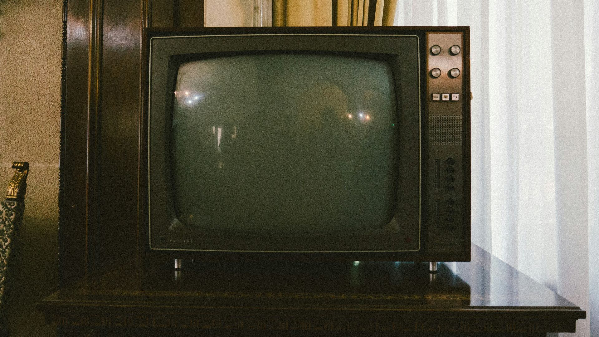 turned-off gray CRT TV on table