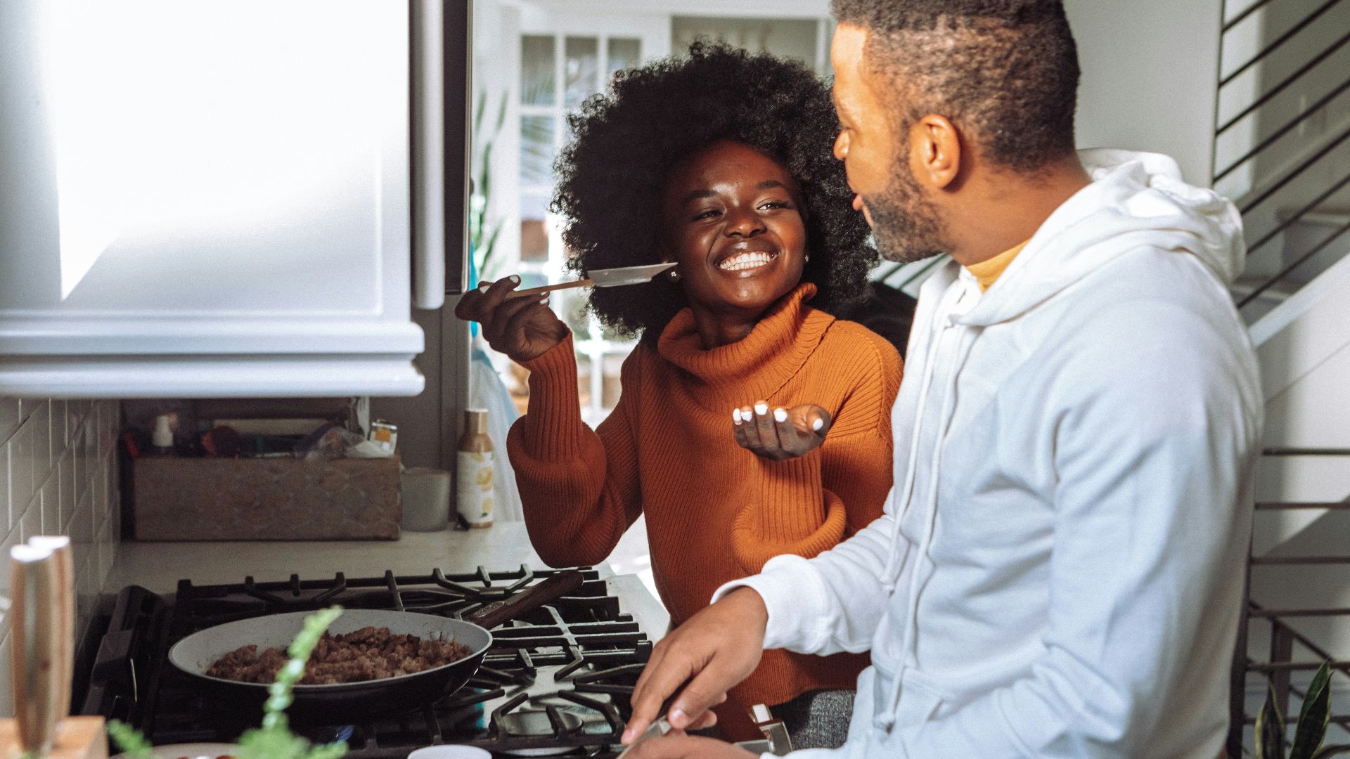 man in white dress shirt holding a woman in brown long sleeve shirt