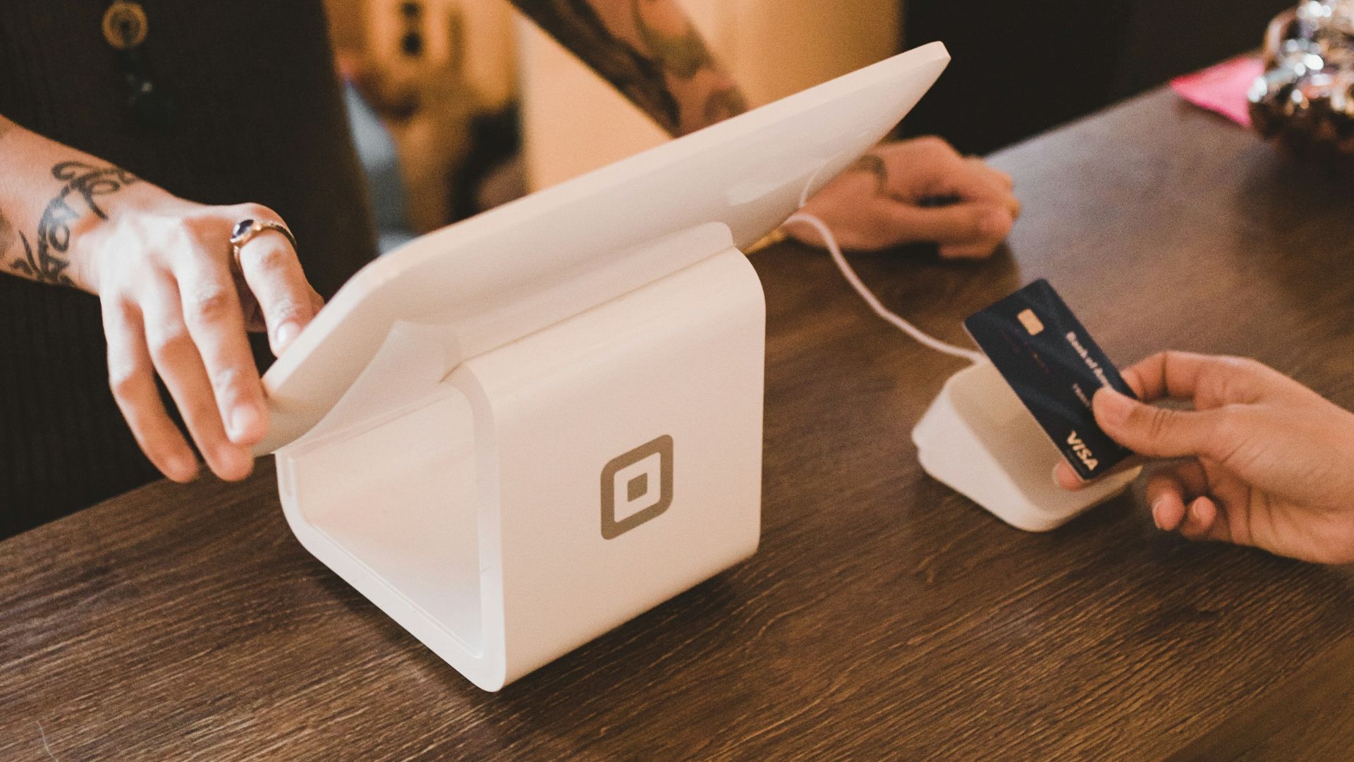person holding white POS machine