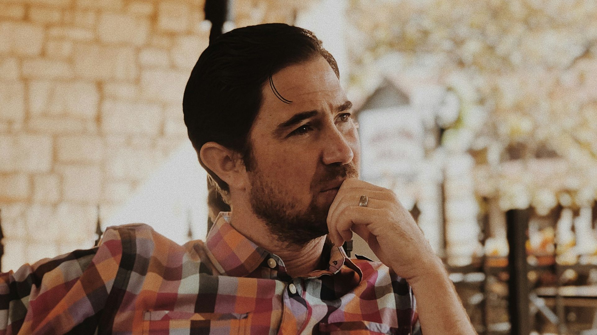 man in red and black plaid dress shirt