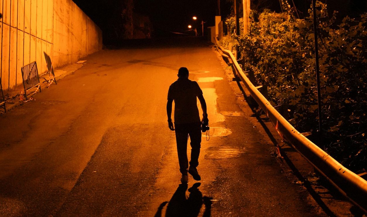 Man walking on a street at night