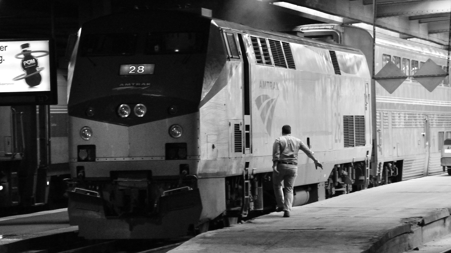 The engineer alights Amtrak's Blue Water train no. 365, led by AMTK 28, after pulling into the south side of CUS on track 14. This train provides passenger service to various points in Michigan and originates in Port Huron.