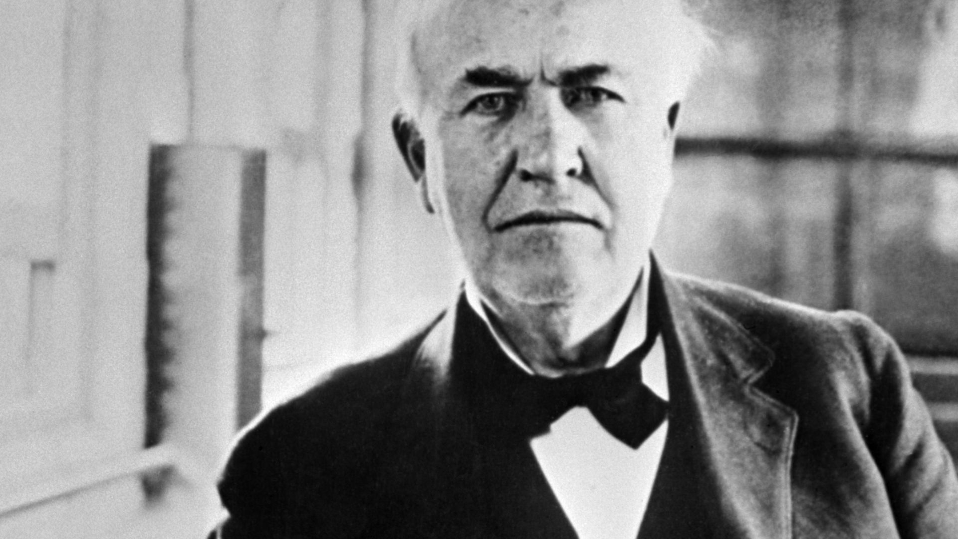 Thomas Edison (1847–1931)  with his invented white light bulbs from 1883.