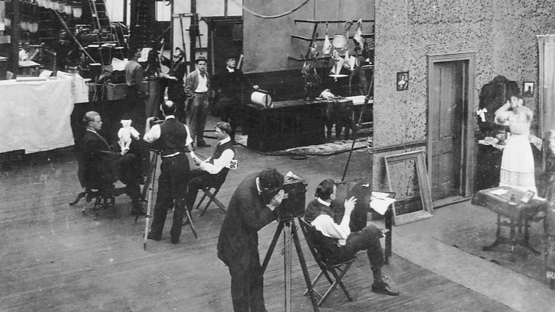 Interior of Edison Motion Picture Studio's main facility in the Bronx, New York City used  between 1907 and 1918. Several productions are shown here in progress simultaneously.