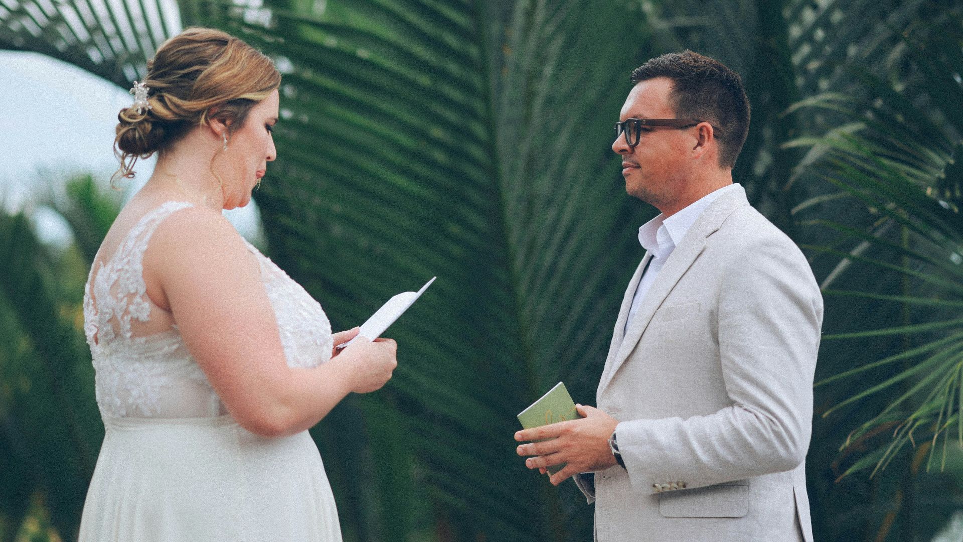 Couple exchanging vows during outdoor wedding ceremony