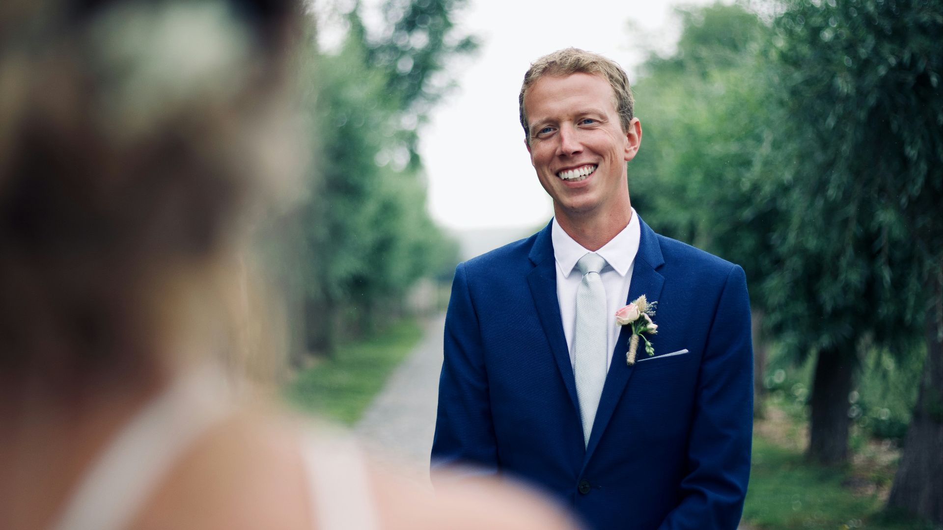 shallow focus photo of man in blue suit jacket