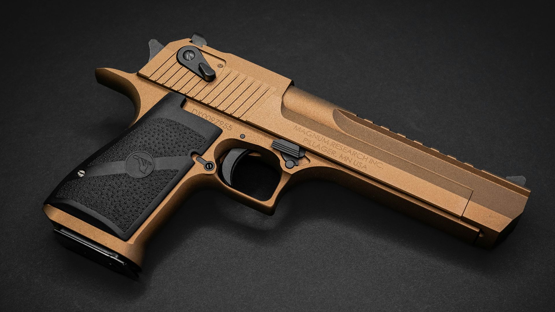 a close up of a gun on a black surface