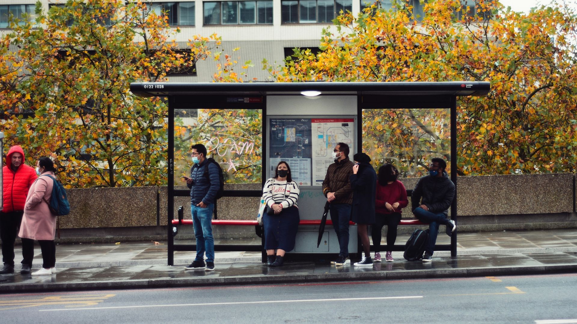 people sitting on bench in front of building during daytime