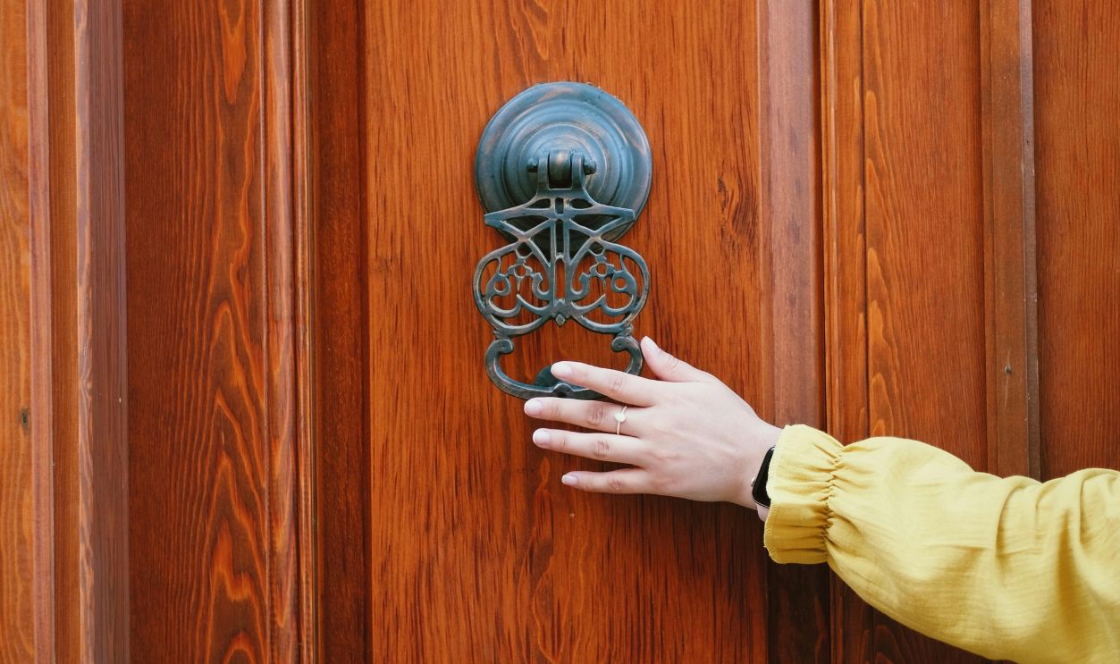 Person Holding a Door Knocker