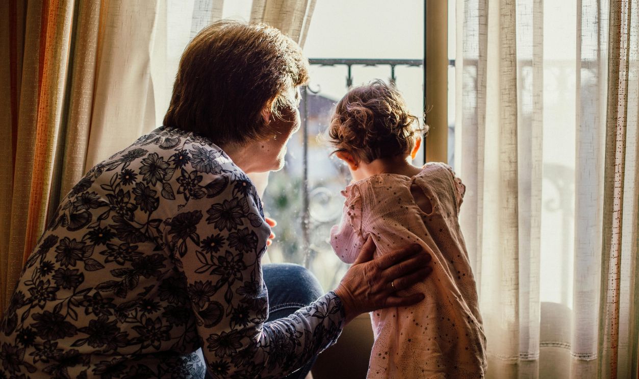Woman Holding Baby Near Window