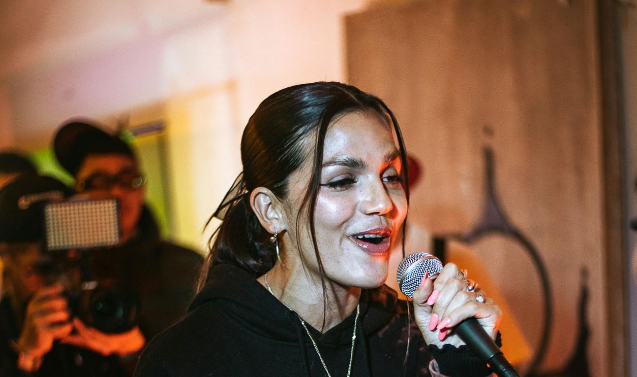 Woman Holding a Microphone on a Party