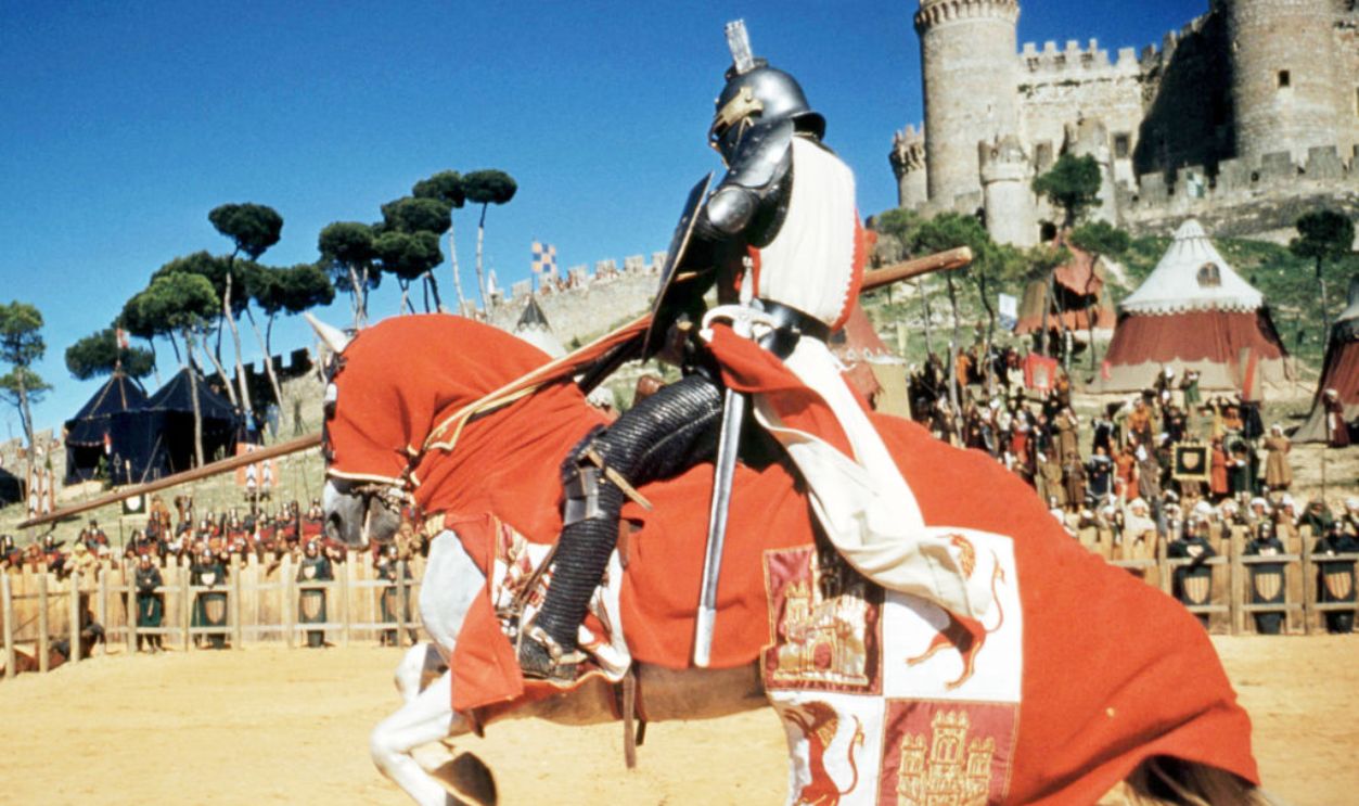 American actor Charlton Heston (1923 - 2008), as El Cid, on horseback in a jousting scene from 'El Cid', directed by Anthony Mann, 1961.