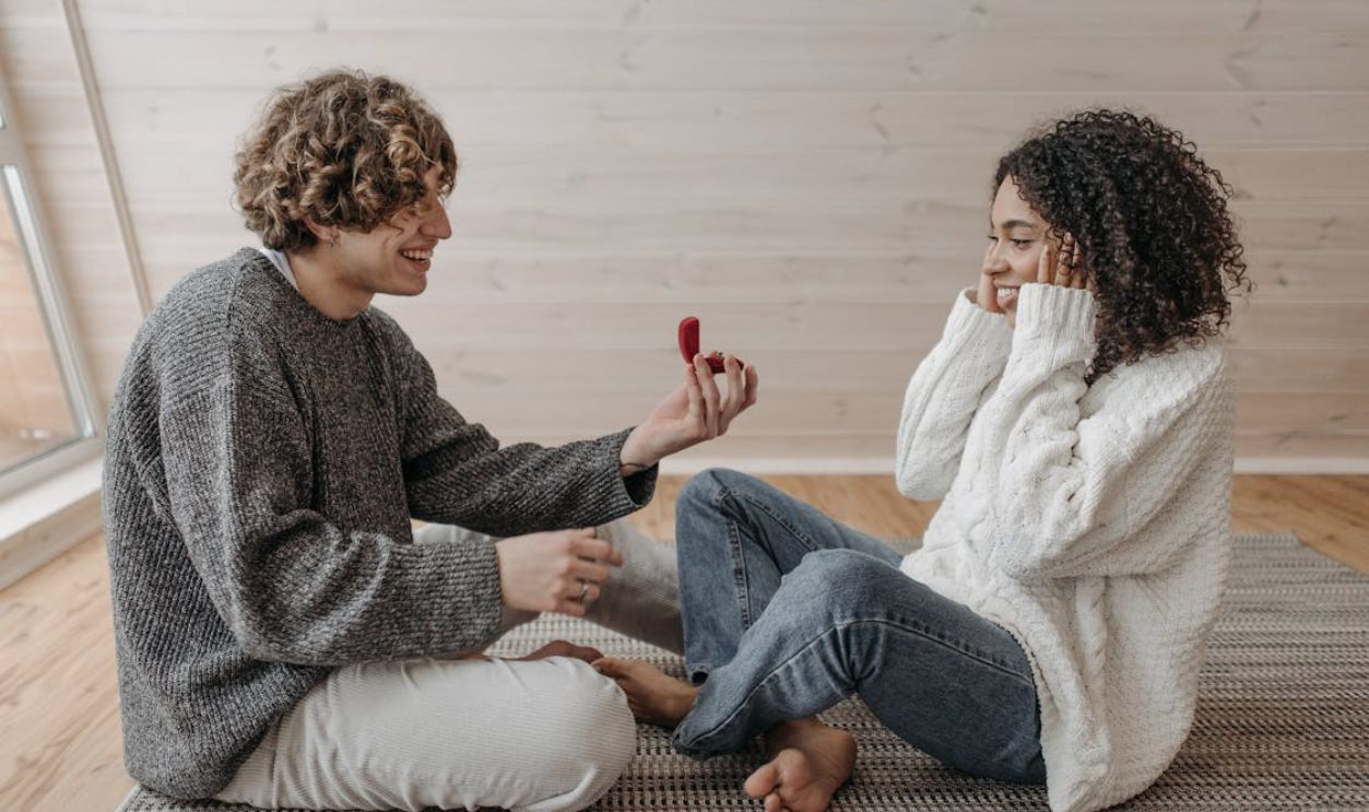 A Man Doing a Marriage Proposal while Sitting on the Floor
