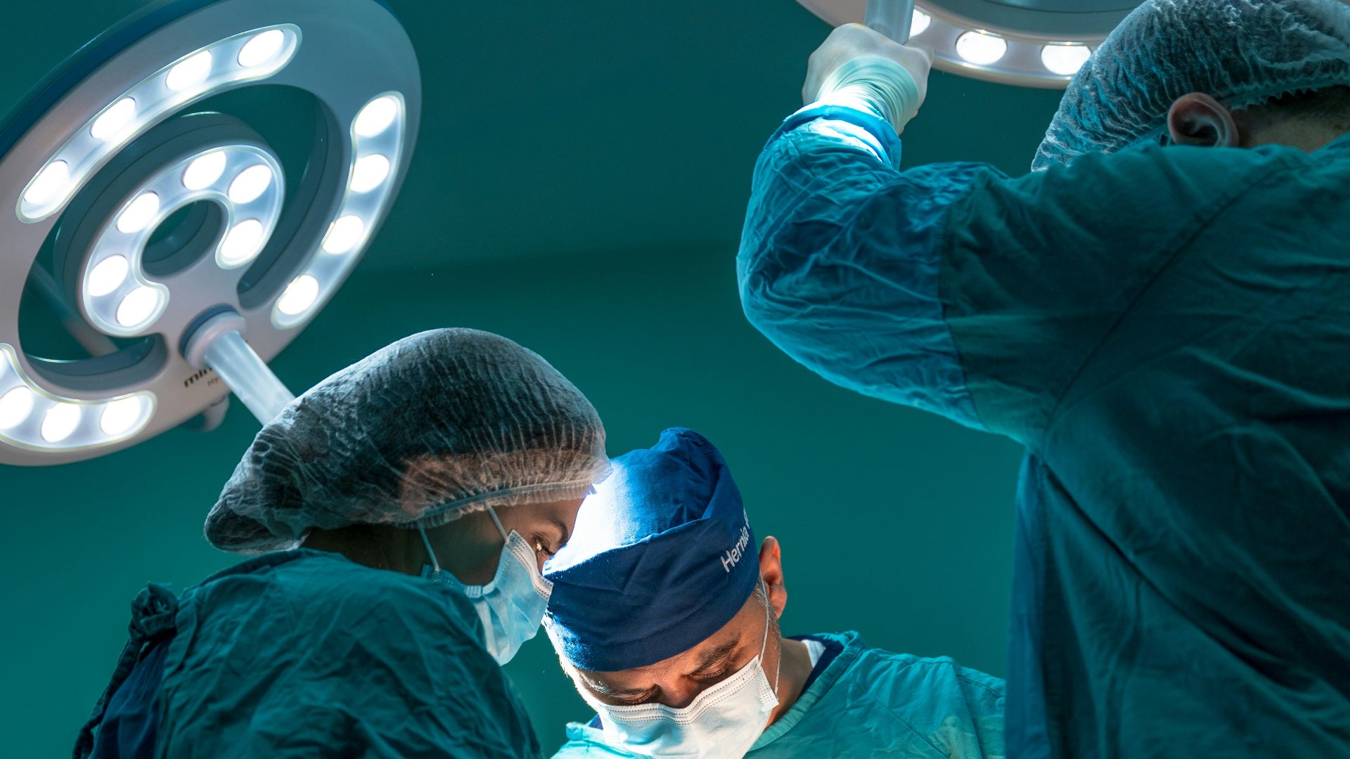 a group of doctors performing surgery on a patient
