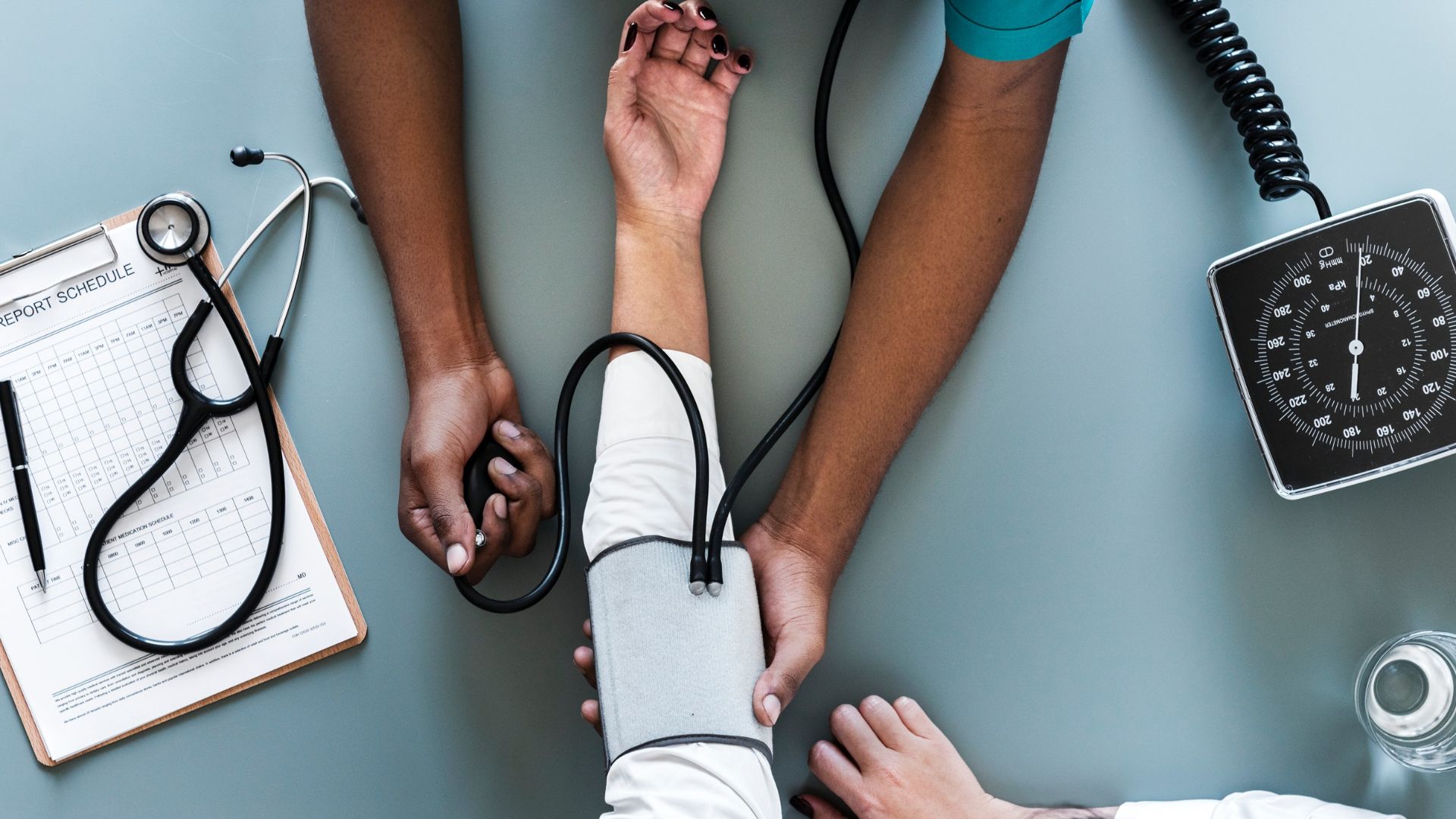 A healthcare professional performing blood pressure monitoring on a patient.
