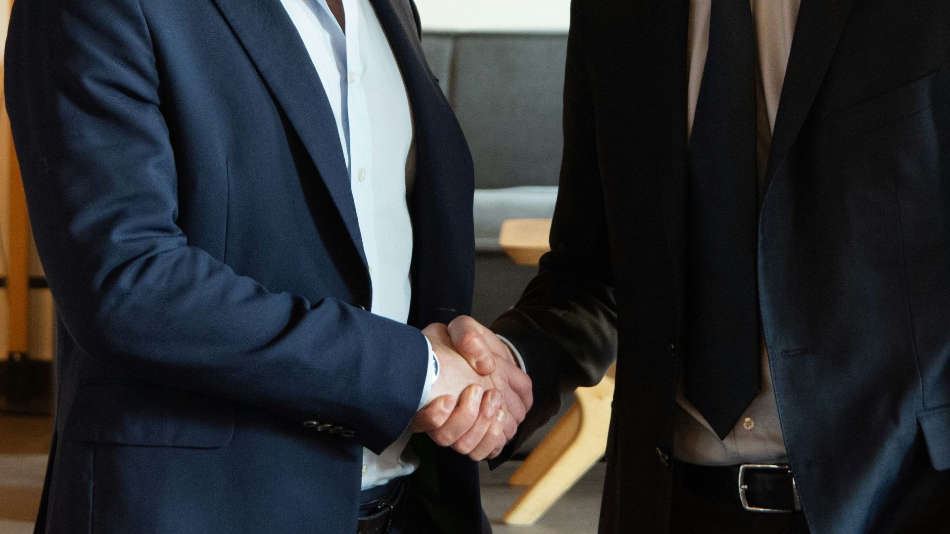 Two business partners shaking hands in agreement.