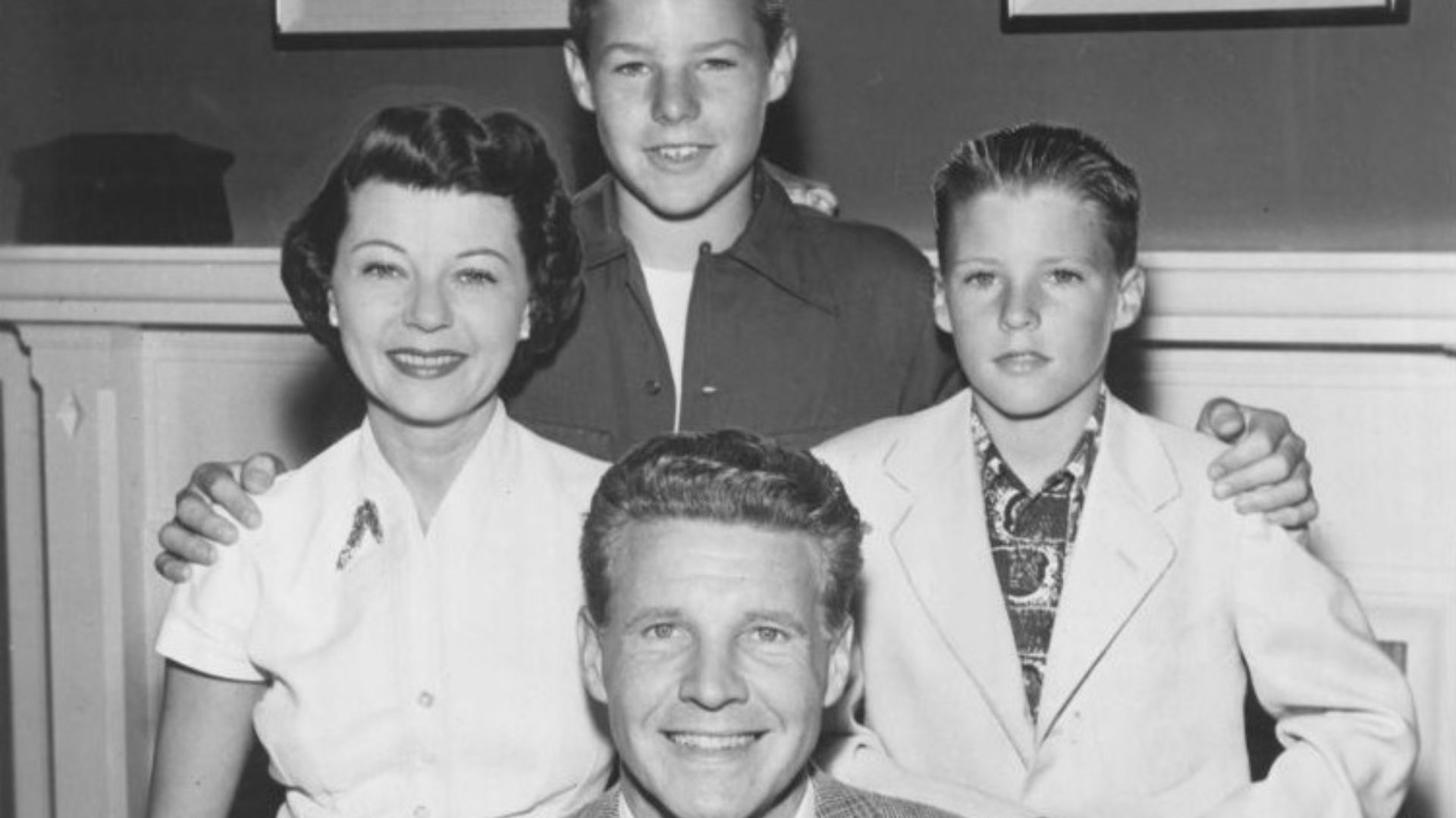 Publicity photo of American actors, (clockwise from front) Ozzie Nelson, Harriet Nelson, David Nelson and Ricky Nelson promoting their roles on the ABC television series The Adventures of Ozzie and Harriet, circa 1952.