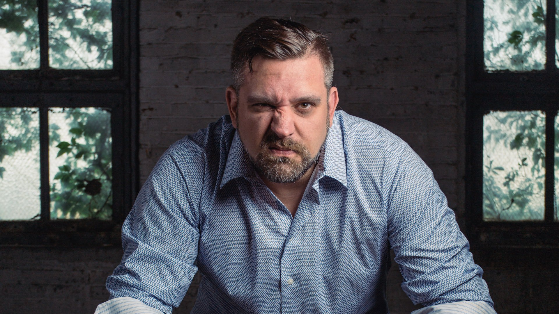 Angry Man Sitting on a chair