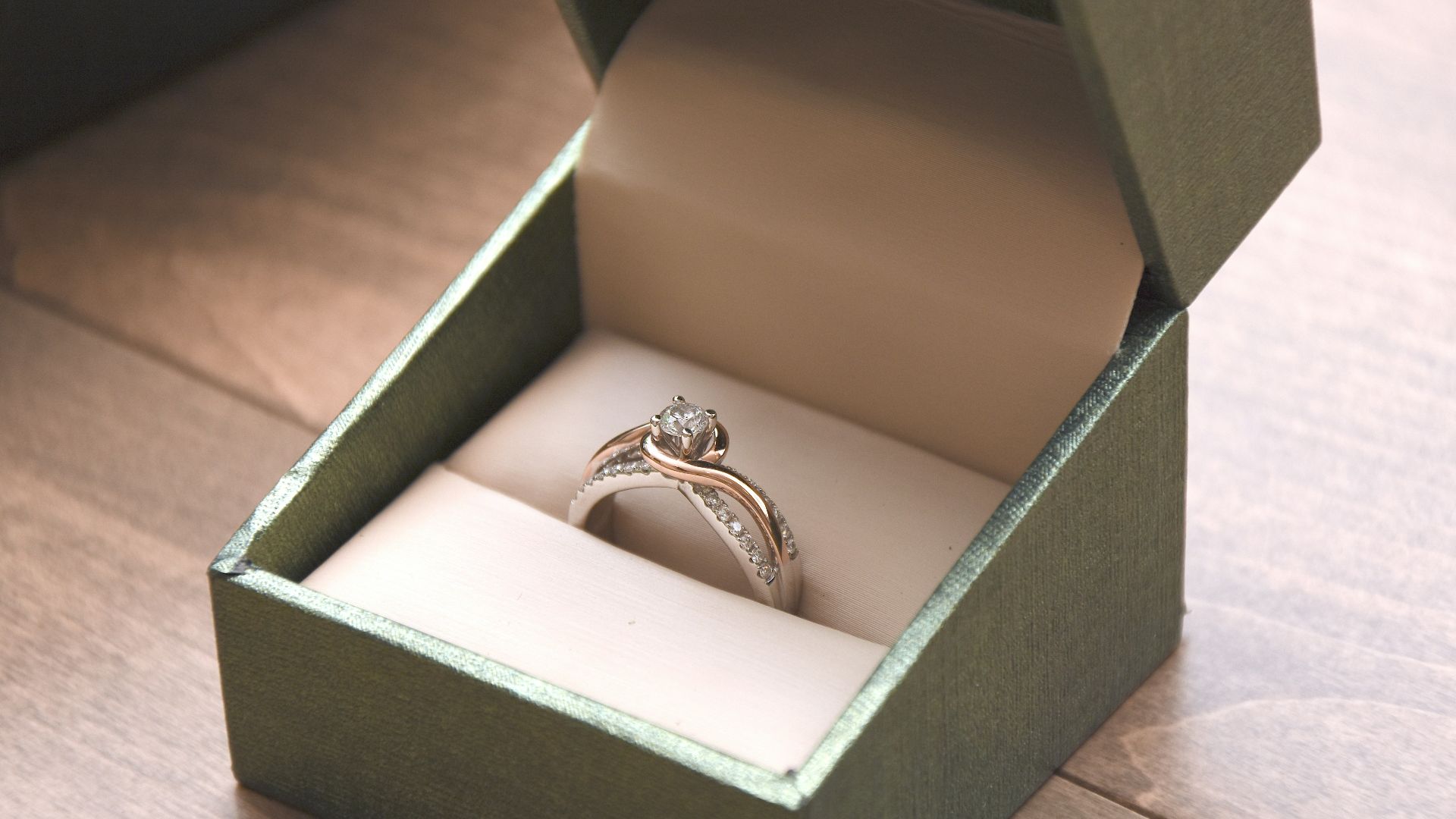 silver-colored ring with gemstone in a box