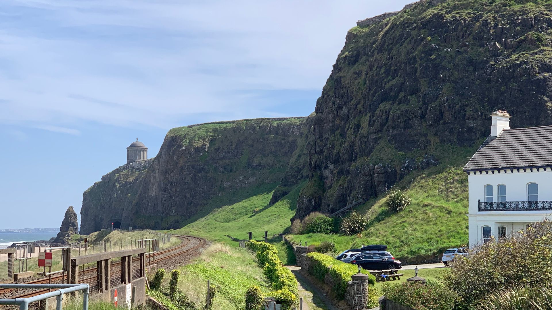 View of coastline at Downhill, Northern Ireland Coast with beach and train line visible.