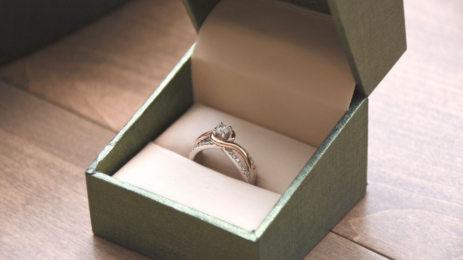 silver-colored ring with gemstone in a box