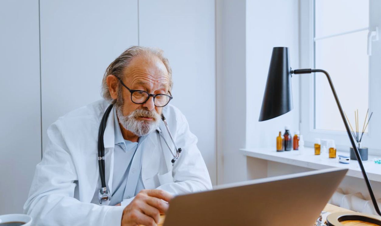 A Doctor in a Video Conference Using a Laptop