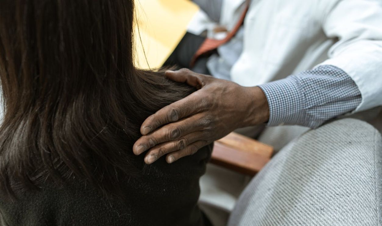 Close-up Photo of Person comforting a Colleague