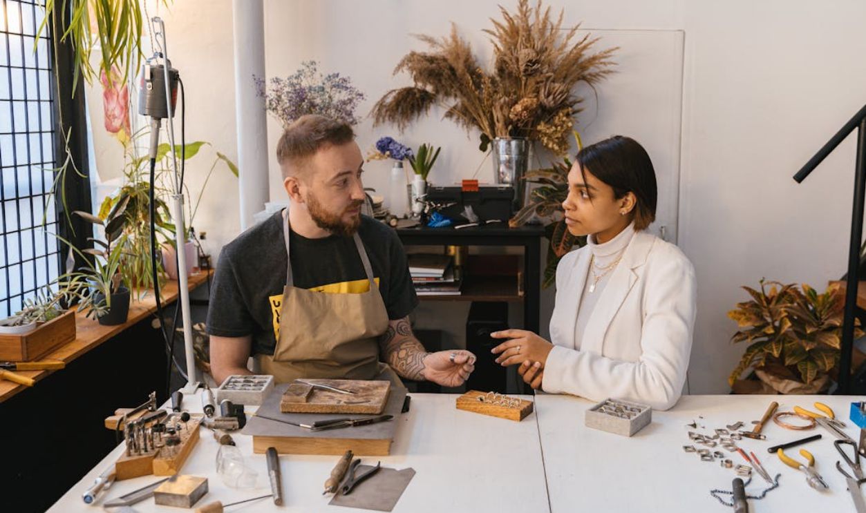 A Man and Woman Having Conversation while Looking at Each Other