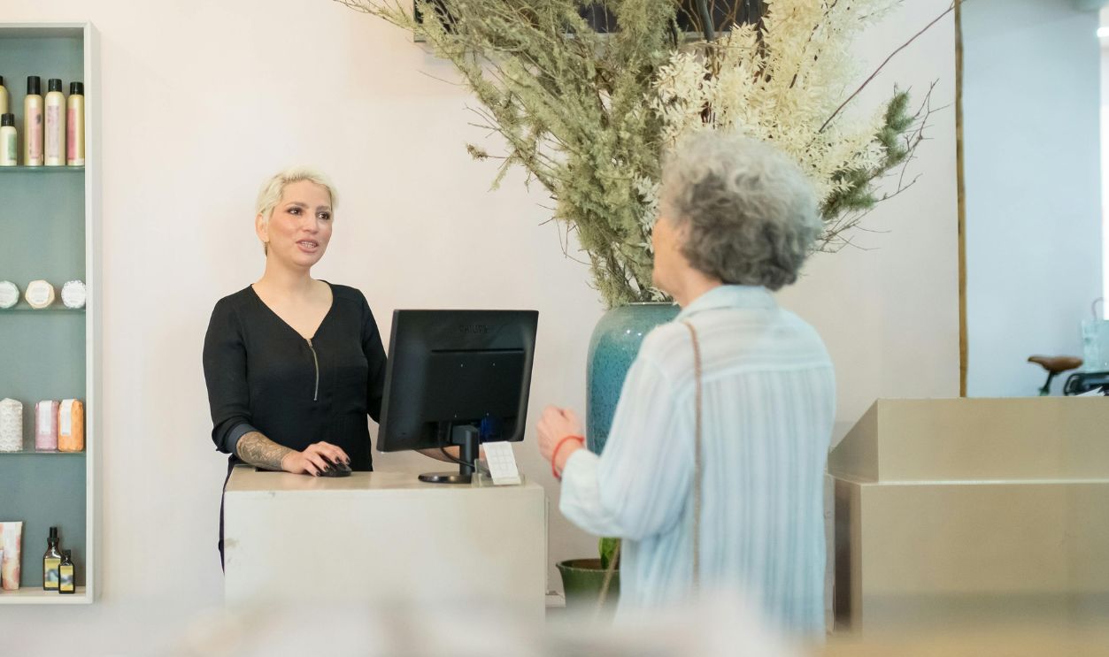Hair Dresser and a Client Talking Inside a Salon