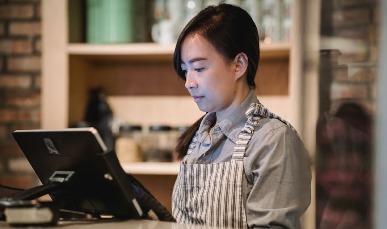 Woman Working at Cash Register