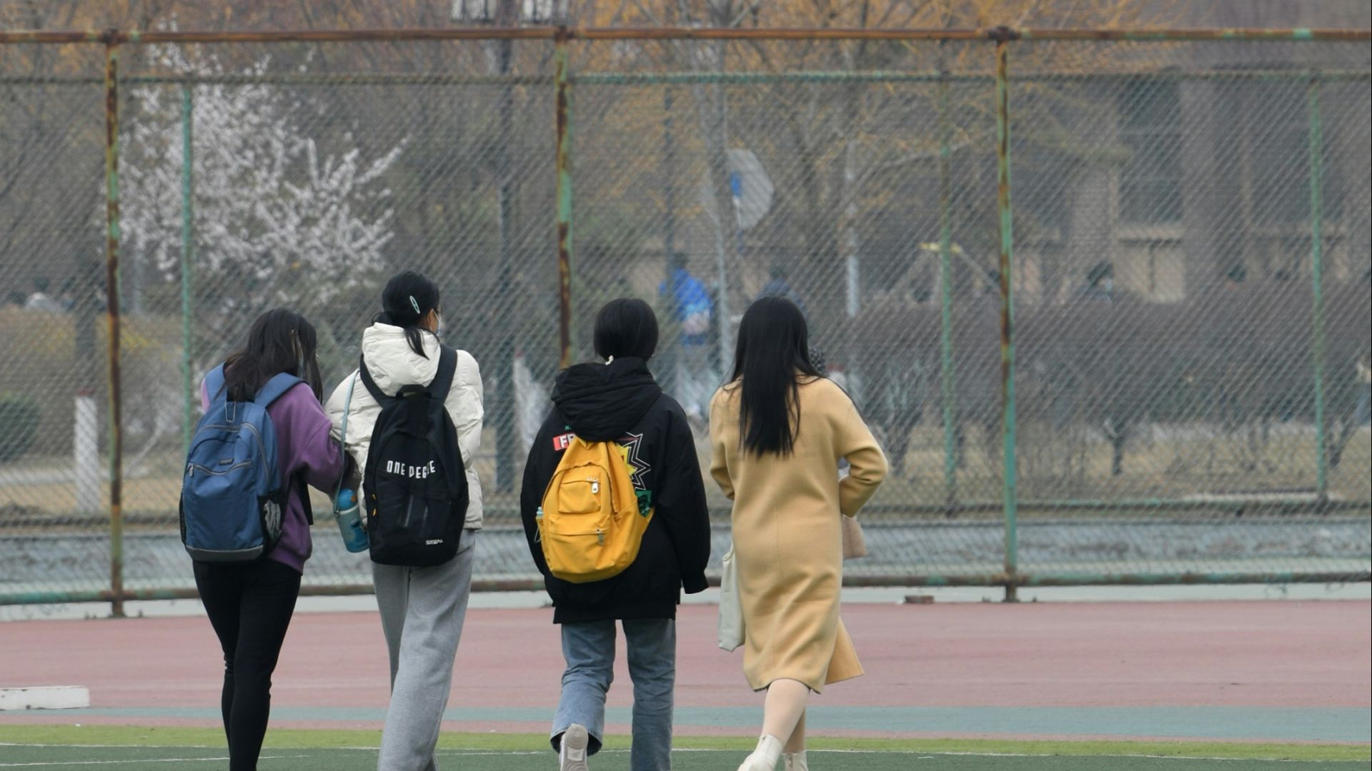 a group of people walking across a field