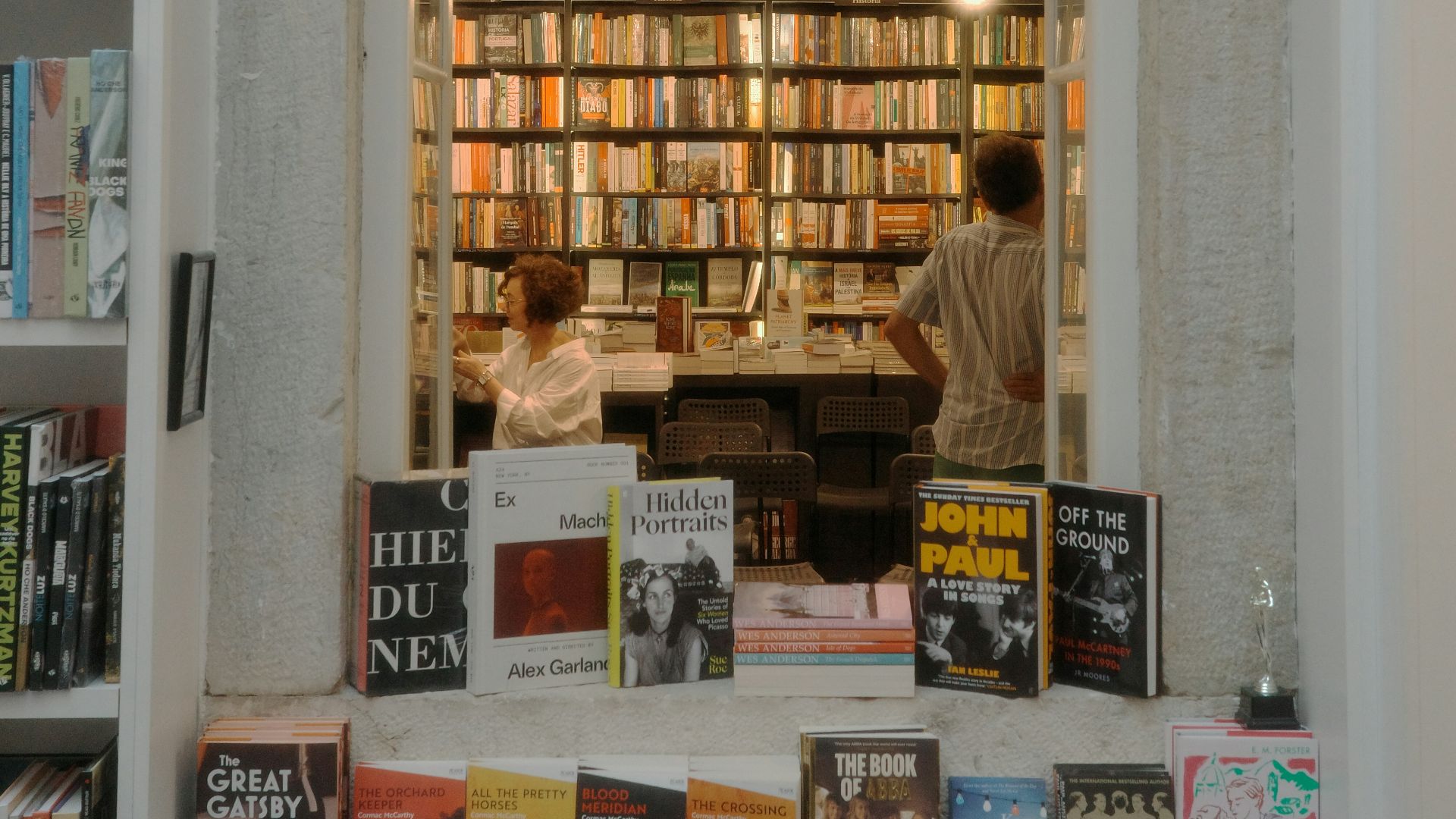 Bookshelves filled with books in a cozy bookstore.