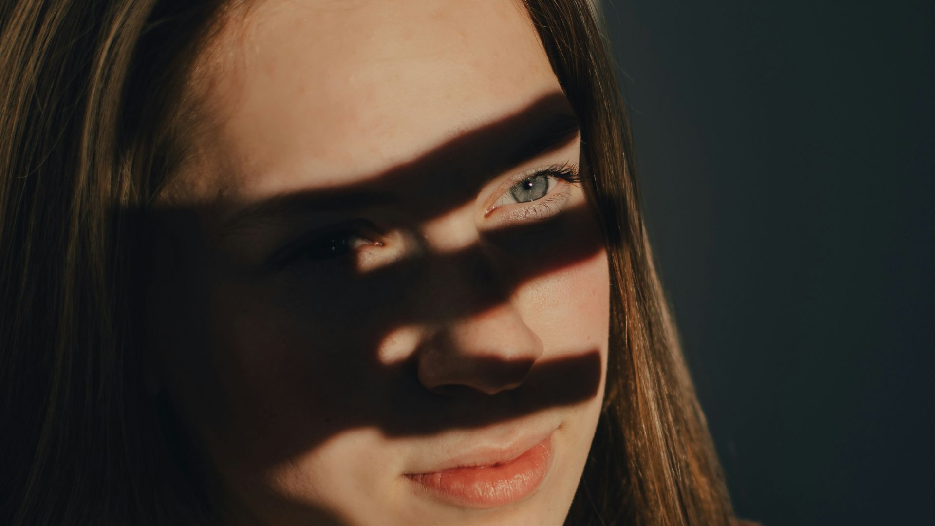 a woman with a shadow cast on her face