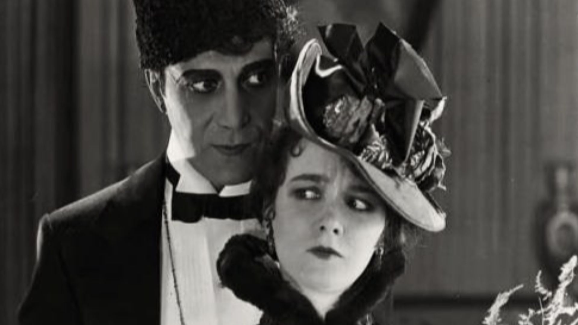 Arthur Edmund Carewe and Mary Philbin in the film The Phantom of the Opera - publicity still (original image damaged, modified & cropped)