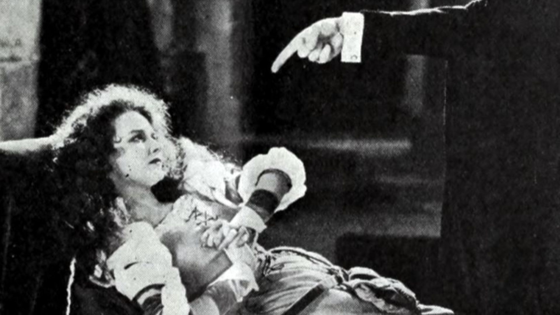 Still from the American horror film The Phantom of the Opera (1925) with Mary Philbin and the arm of the Phantom, on page 13 of the January 17, 1925 Universal Weekly.