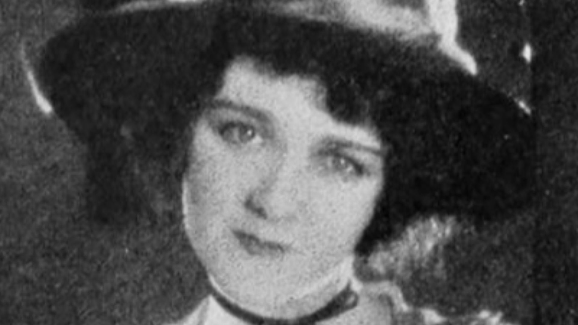 Still from the American romantic drama film Love Me and the World Is Mine (1928) with Mary Philbin, on page 12 of the February 4, 1928 Universal Weekly.