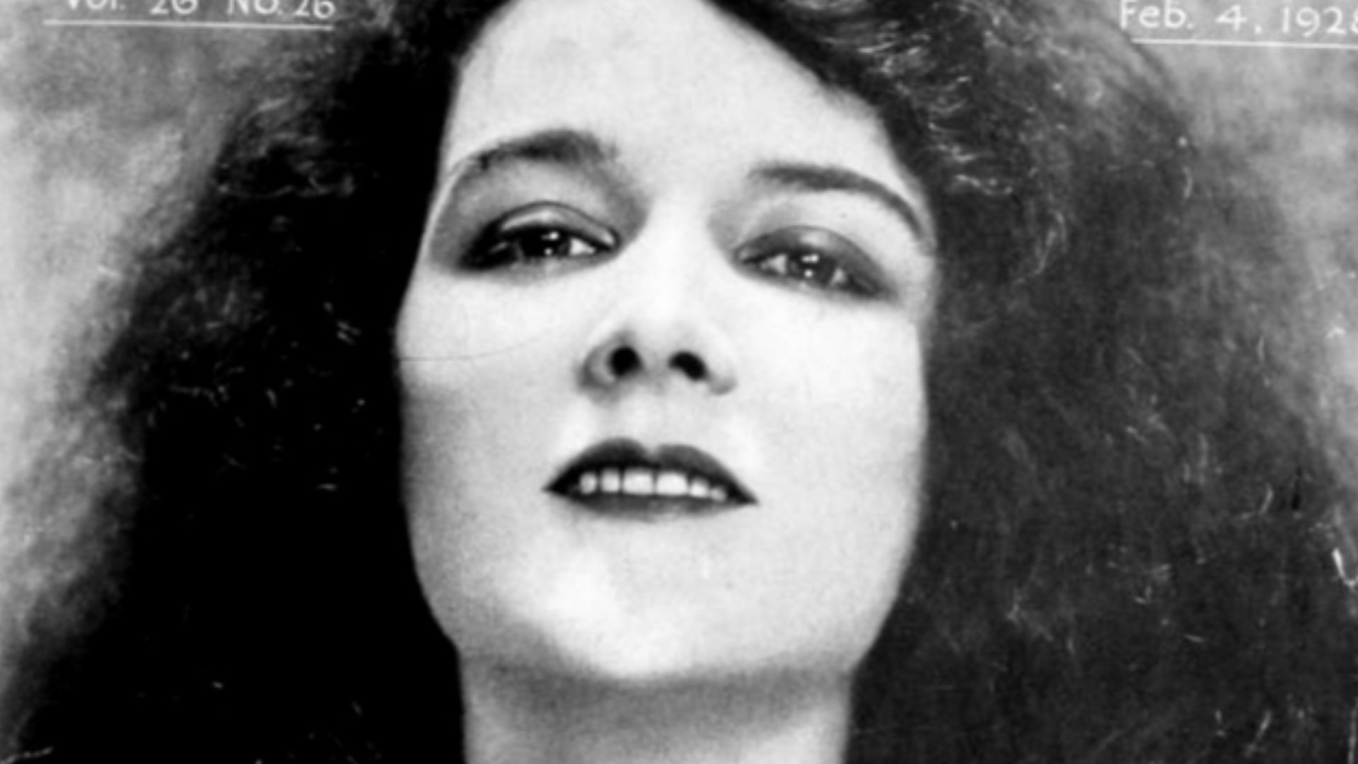 Still from the American romantic drama film Love Me and the World Is Mine (1928) with Mary Philbin, on the cover of the February 4, 1928 Universal Weekly.