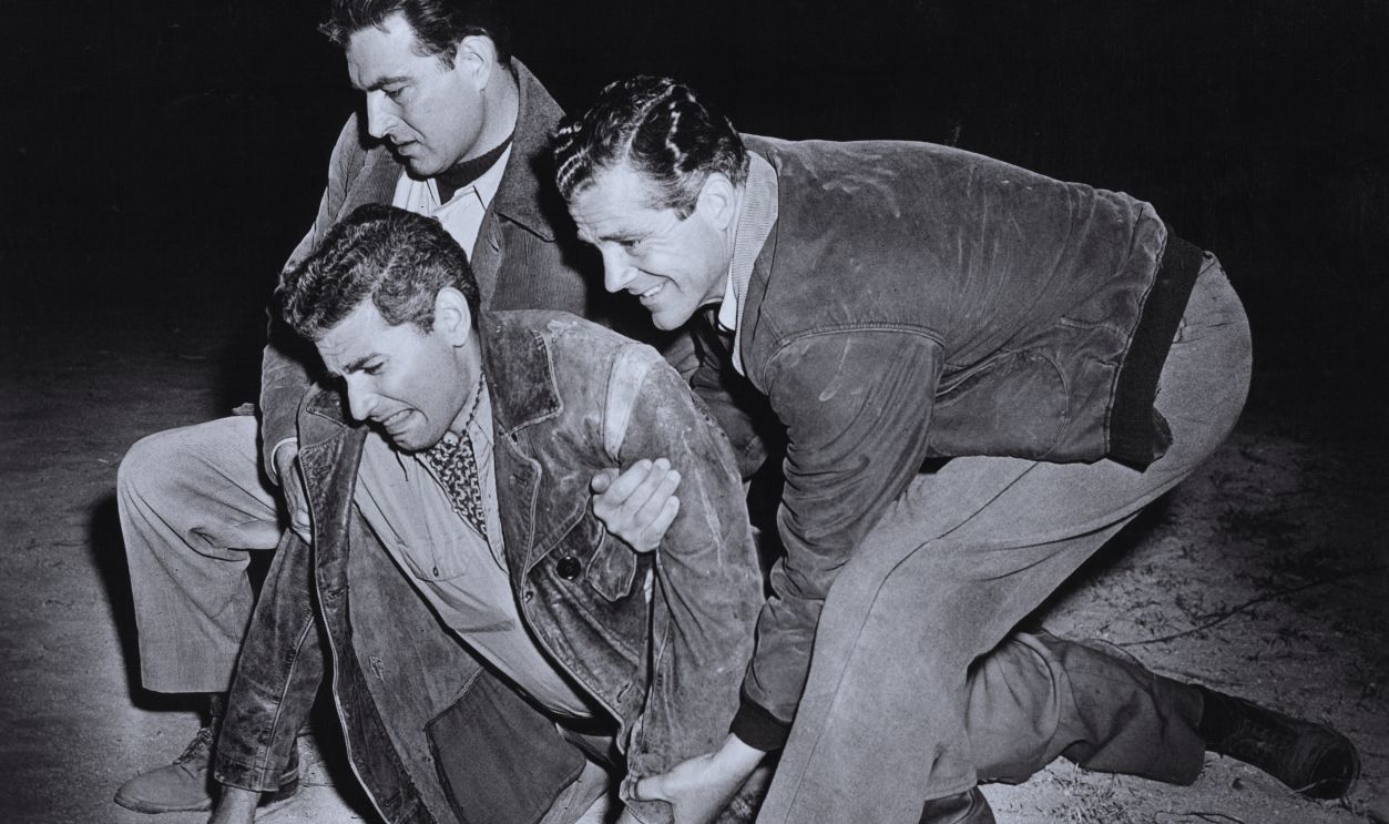 Gettyimages - 143769636, Jeff Chandler In 'Sword In The Desert' Jeff Chandler being picked up by Stephen McNally and Dana Andrews in a scene from the film 'Sword In The Desert', 1949. 