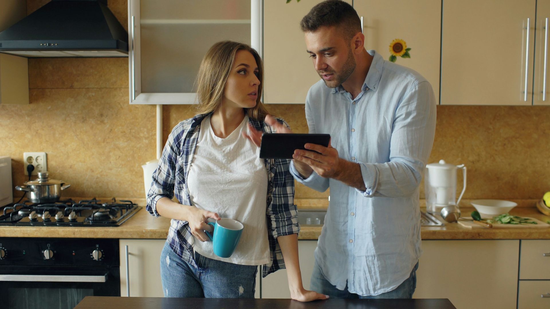 Couple looking at tablet in kitchen